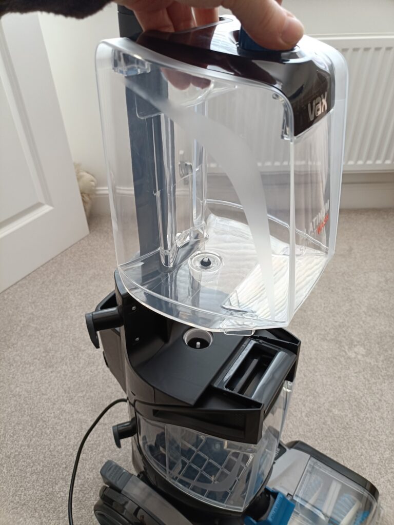 Pull up to remove the carpet cleaner water tank
