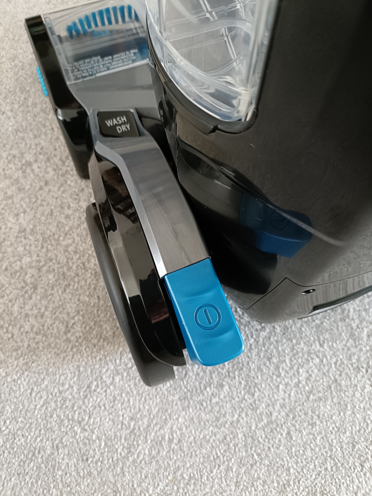 Power pedal at the back left of the carpet cleaner