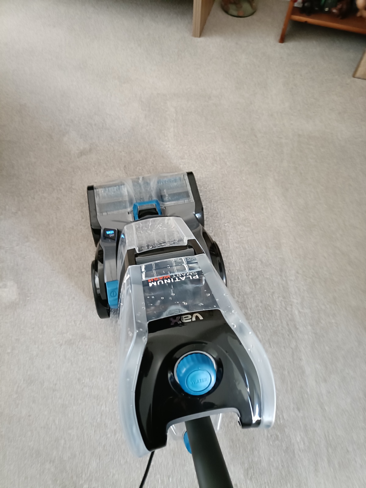 Pushing carpet cleaner forward on wash cycle