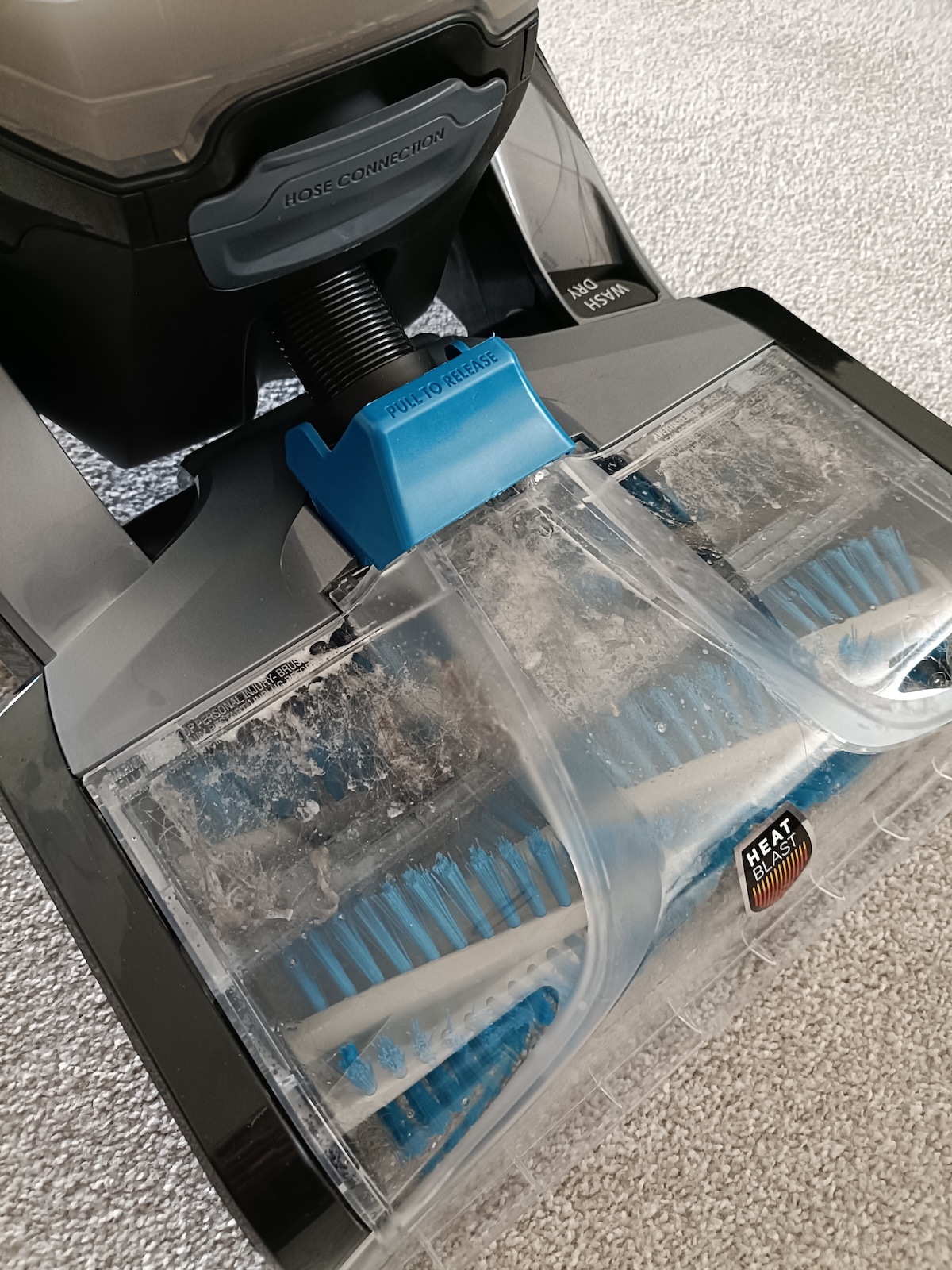 Dirty liquid being sucked up the front of the Platinum SmartWash carpet cleaner
