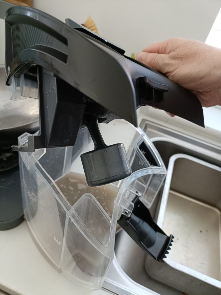 Lifting off the lid of the dirty water container