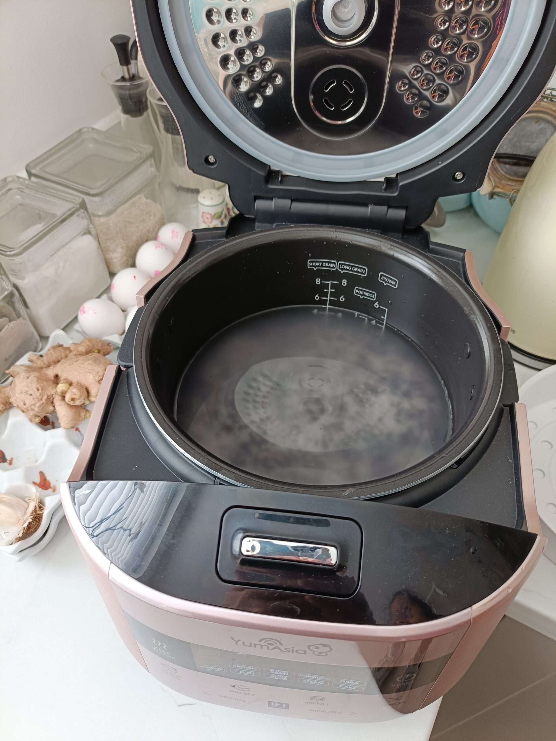 Rice and water in the bowl of a rice cooker