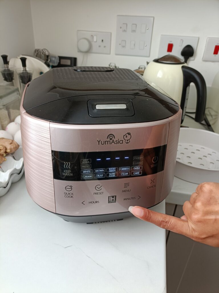 Selecting settings on the front of the Yum Asia rice cooker