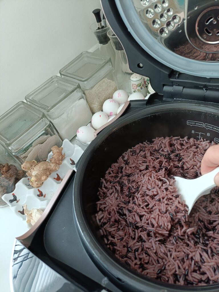 Spooning out cooked rice from a rice cooker